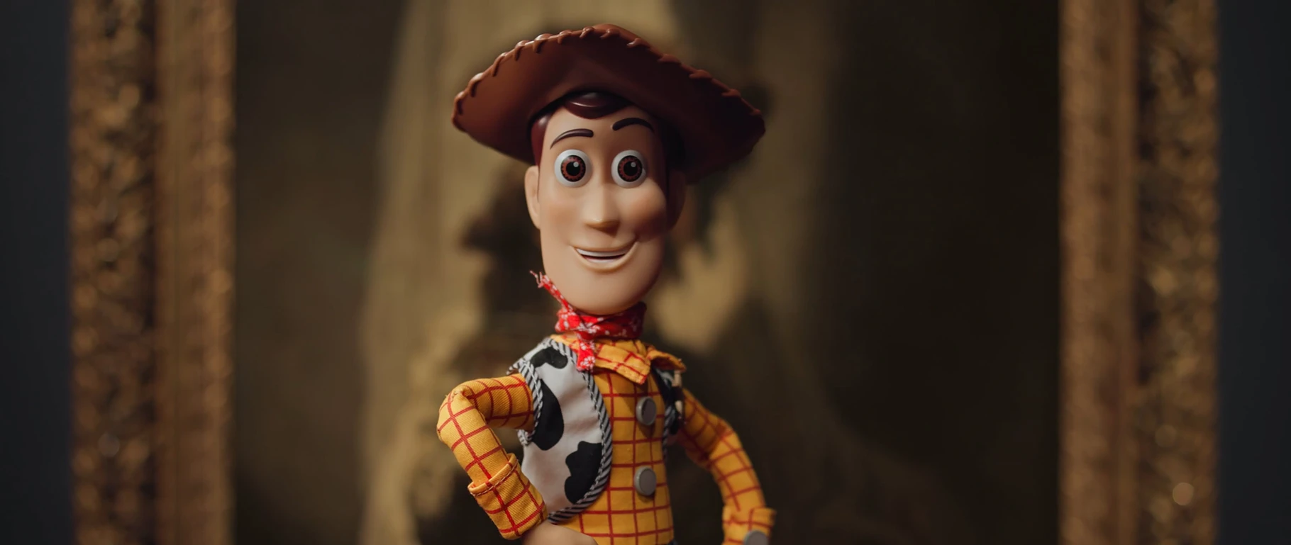 A Woody figure from Toy Story posed hands on hips in front of a gilt-framed Old Master portrait at the Rijksmuseum