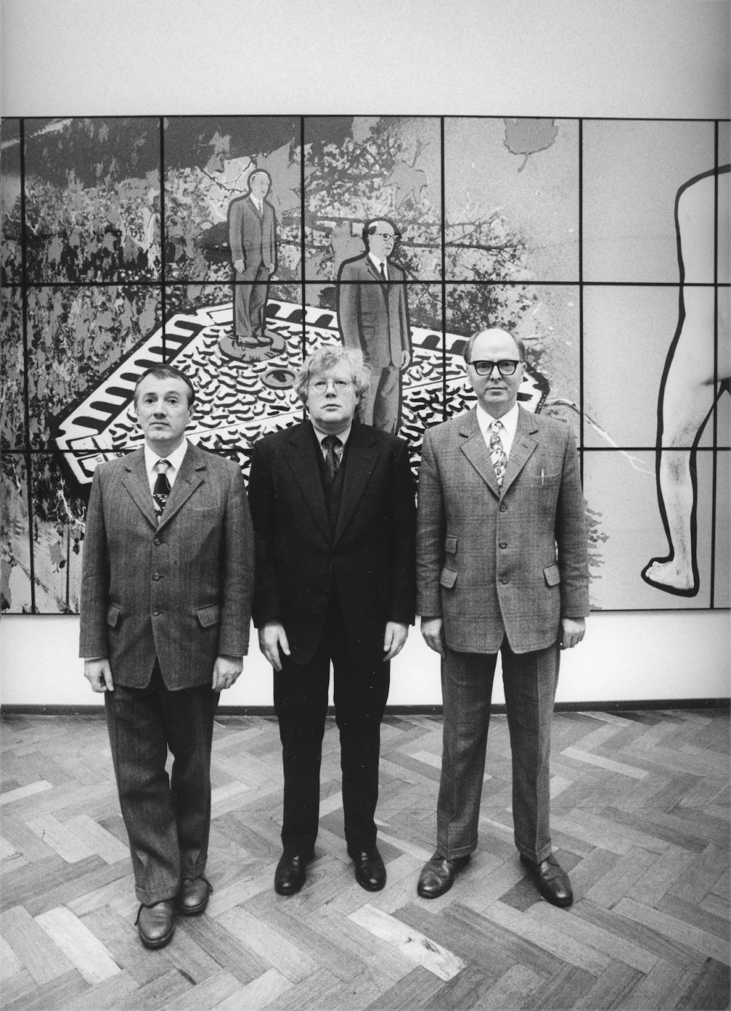 Rudi Fuchs standing with artists Gilbert and George at the Stedelijk Museum in 1998
