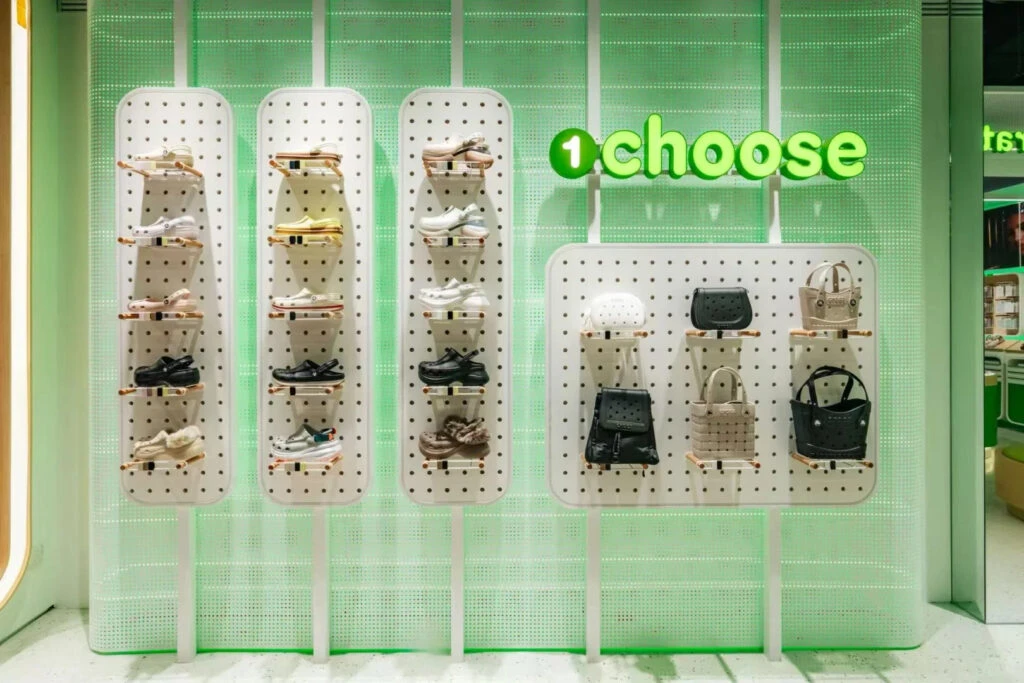 Charm selection wall organized by color family at Crocs by You