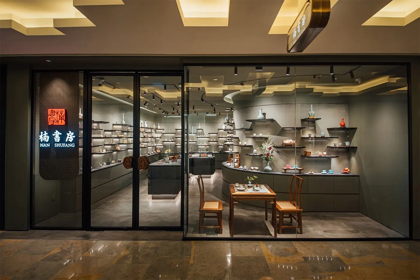 Gold and silver wares displayed on a low table inside the Pacific Place store