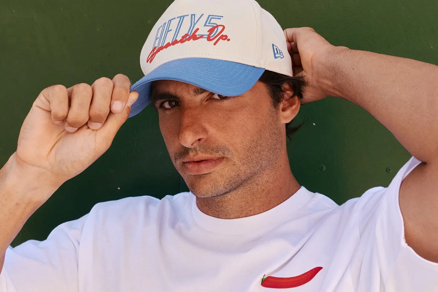 Carlos Sainz wearing New Era TEAM FIFTY5 yellow cap and apparel in campaign image