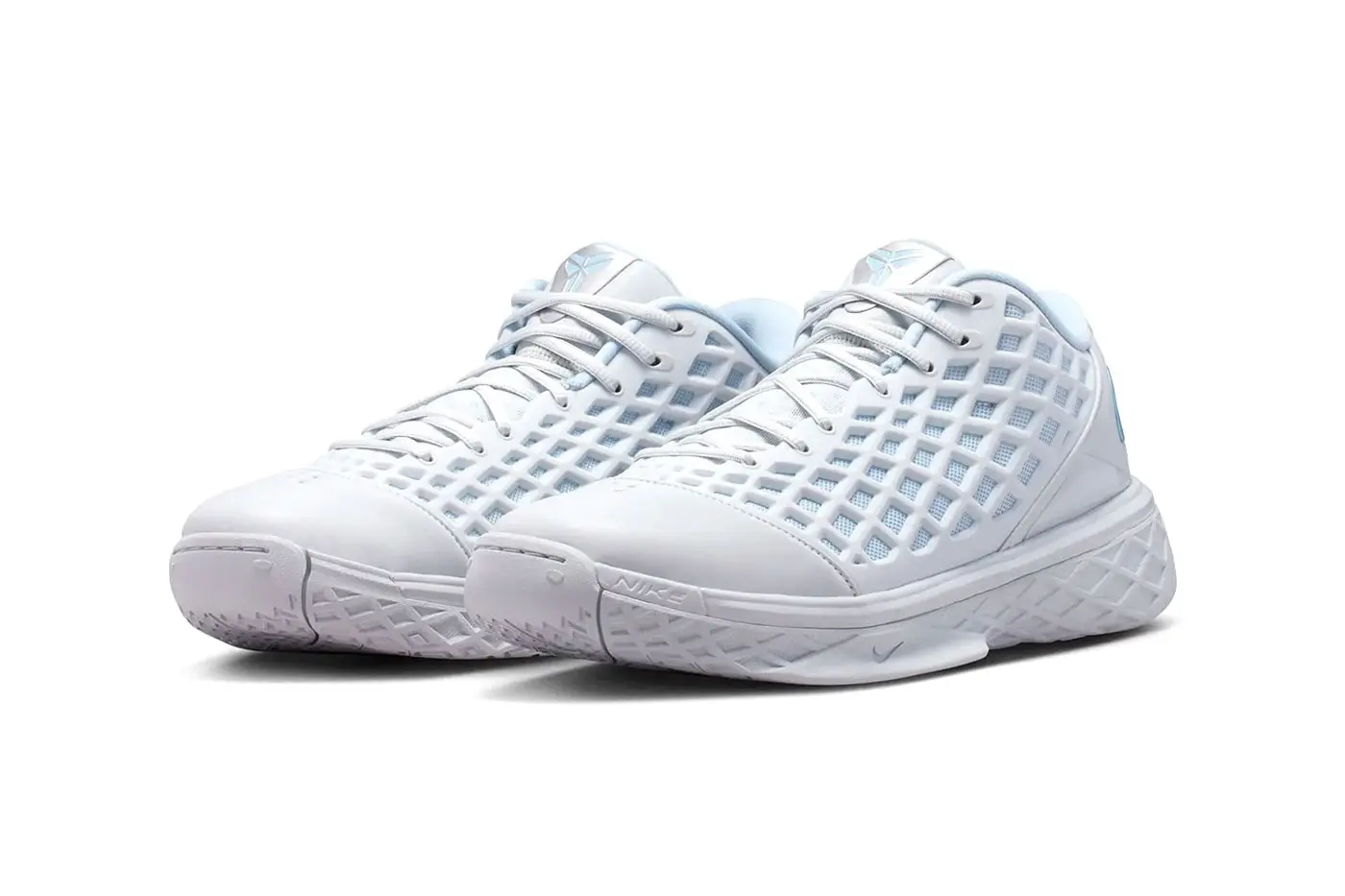 Heel view of the Kobe 3 Low Protro Pure Platinum pair, metallic Armory Blue Swoosh on each heel