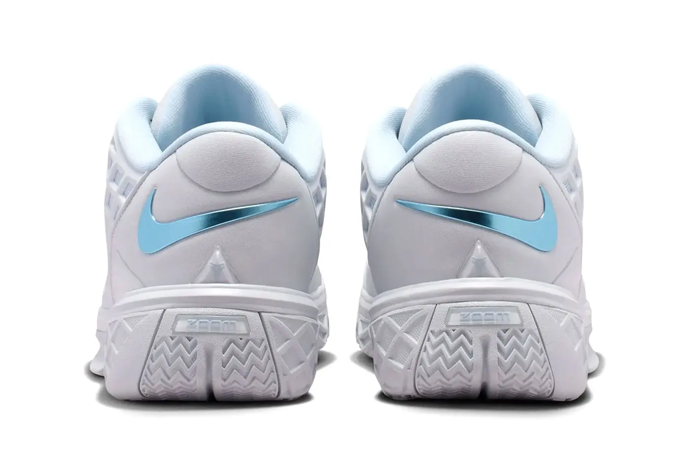 Angled view of the Kobe 3 Low Protro Pure Platinum pair showing the lattice cage and outsole tooling