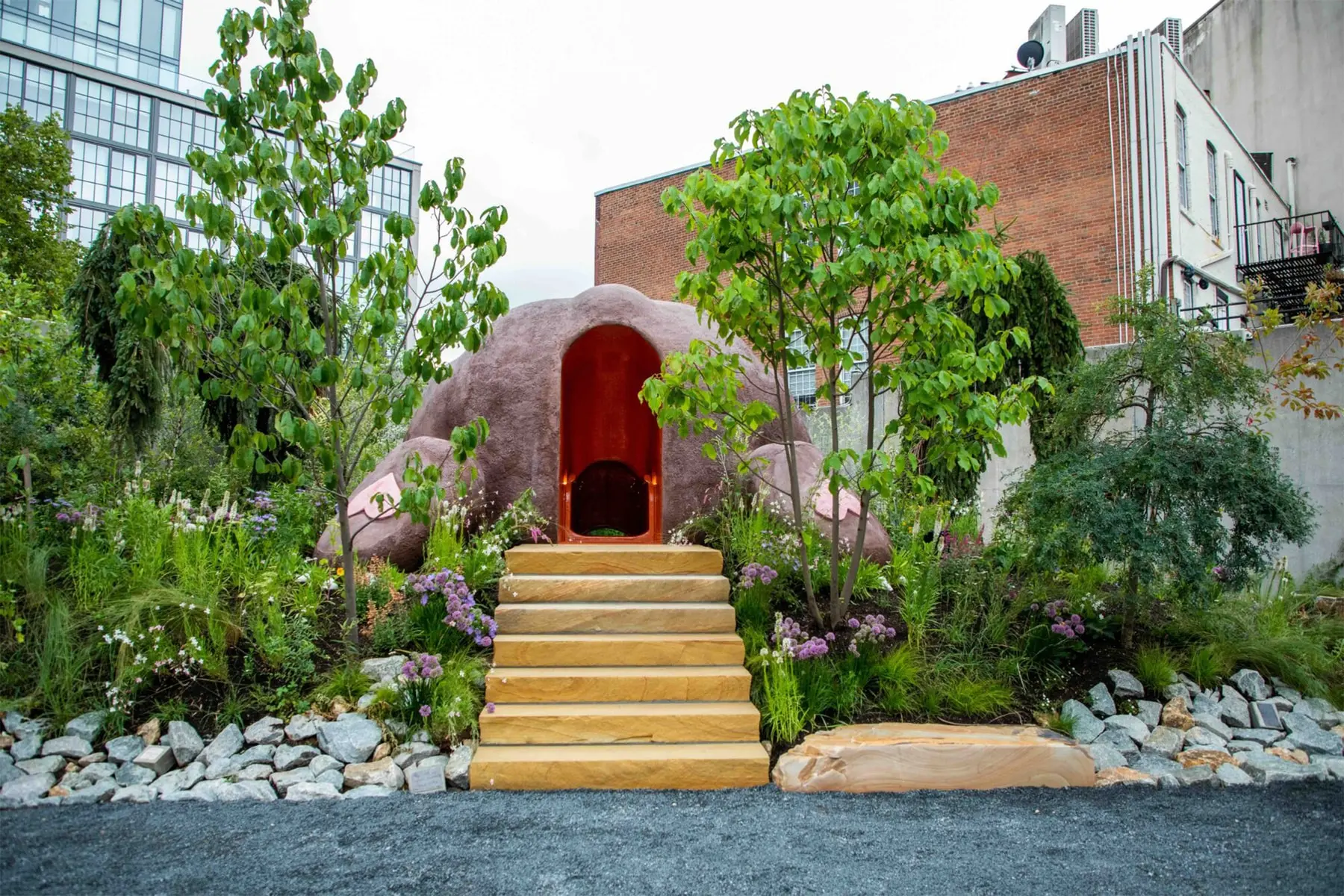Wider angle of Okoyomon's installation showing scale of teddy bear against PS1's courtyard architecture
