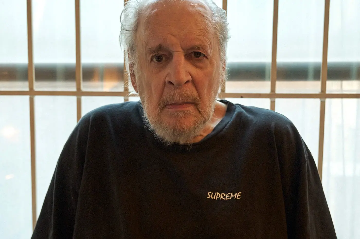Supreme x Larry Clark hooded varsity jacket printed with a black and white Tulsa still
