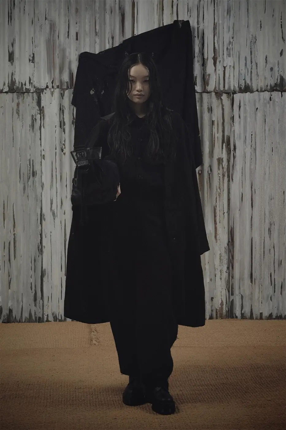 Model wearing oversized black jacket with visible quilt texture from Y's x FAF